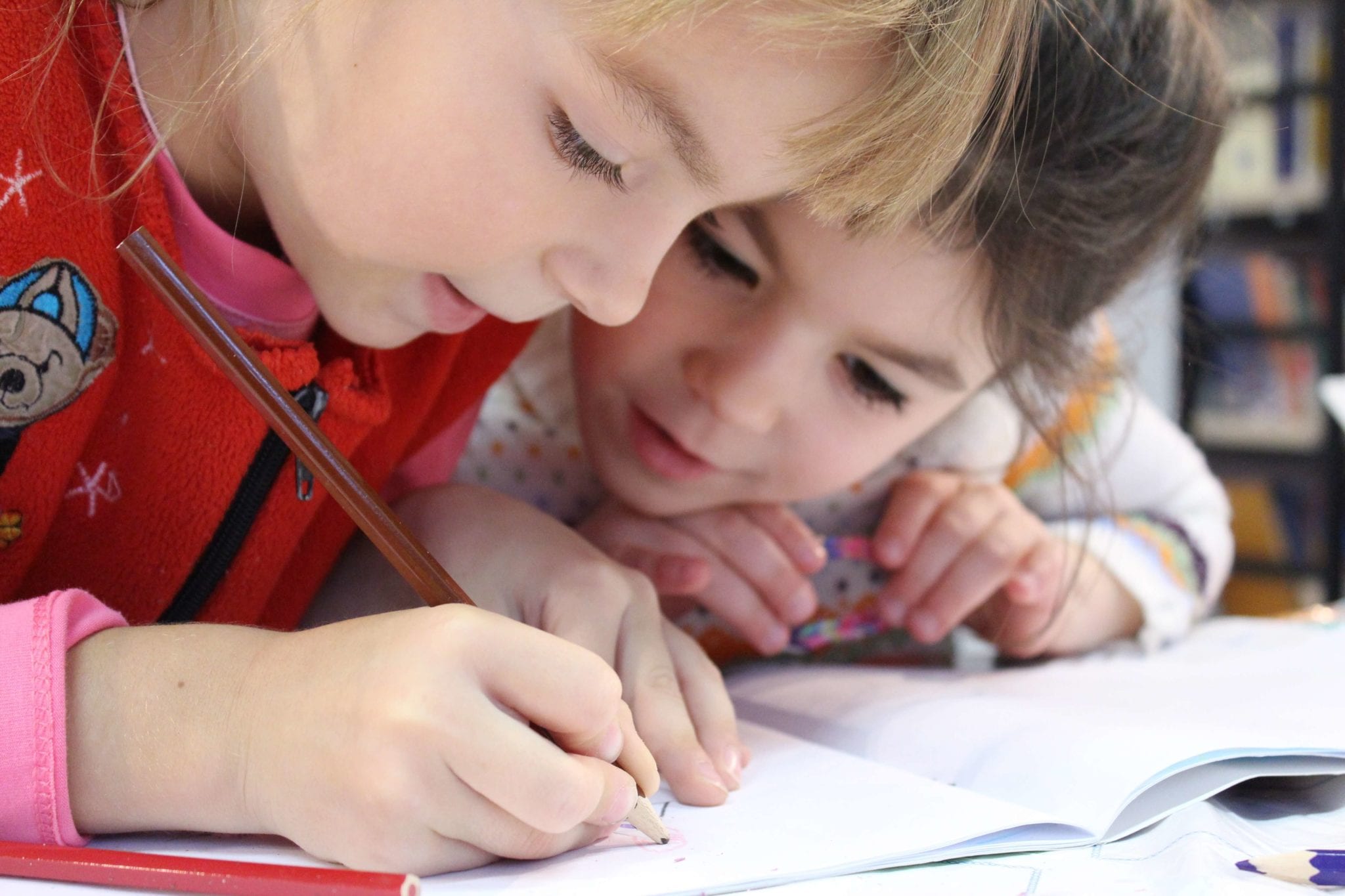 girls drawing with colored pencil