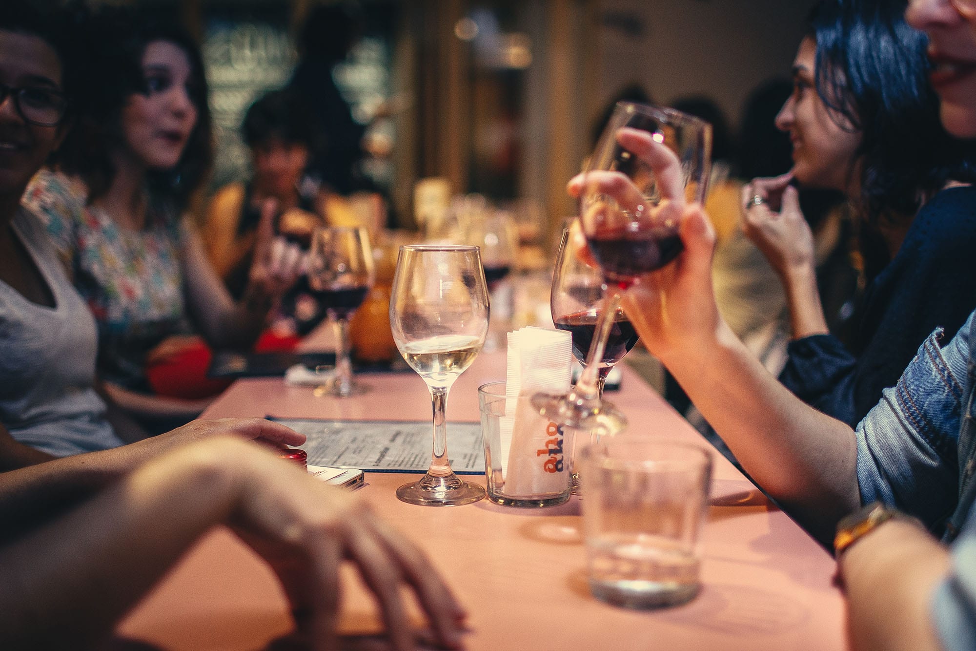 table full of happy people drinking wine